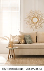 Comfortable sofa with pillows, side table and different decor in room. Interior design