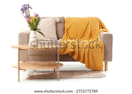 Comfortable sofa, table and vase with beautiful flowers isolated on white background