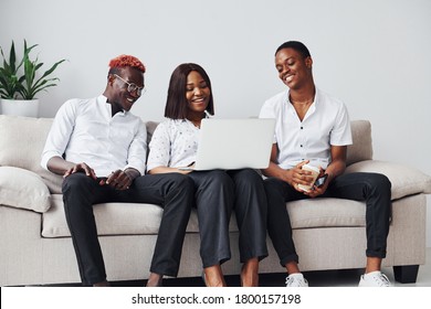 Comfortable Sofa. Using Laptop. Group Of African American Business People Working When Sitting Together.