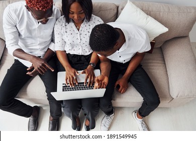 Comfortable Sofa. Using Laptop. Group Of African American Business People Working When Sitting Together.