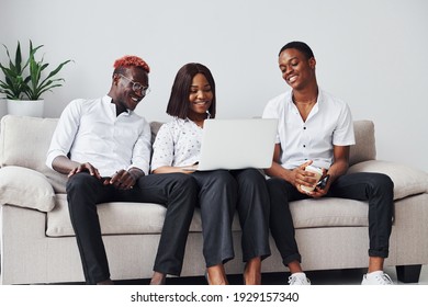 Comfortable Sofa. Using Laptop. Group Of African American Business People Working When Sitting Together.