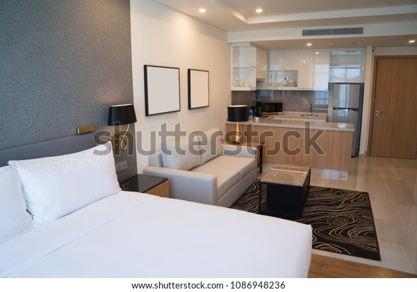 Comfortable studio apartment design. Hotel room\
interior with bedroom area, living space and kitchen corner.\
Apartment and interior\
concept