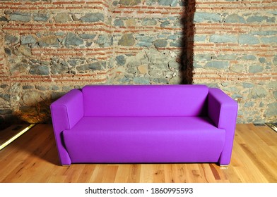 Comfortable And Stylishly Designed Purple Office Chair In Front Of A Wall