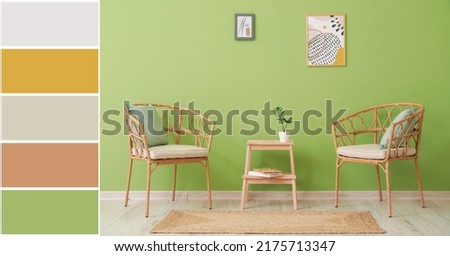 Comfortable wicker chairs and stepladder stool near green wall in room. Different color patterns