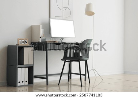 Comfortable workplace with computer in interior of office