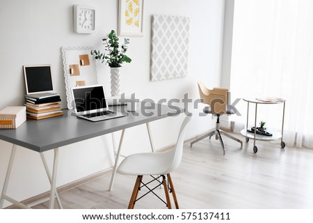 Comfortable workplace with laptop in office