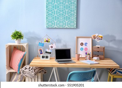 Comfortable workplace with laptop on table in modern room