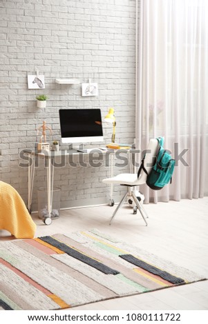 Comfortable workplace with modern computer in child room