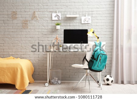 Comfortable workplace with modern computer in child room