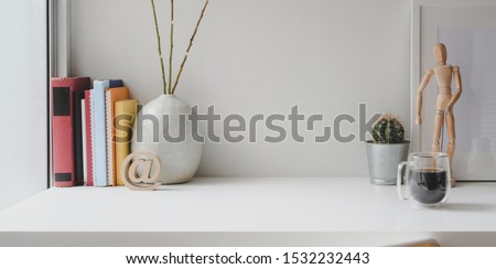 Comfortable workspace with books, office supplies and copy space on white wooden table 