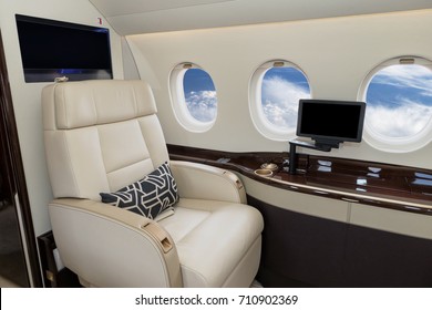 Comfortible cabin chair in a modern business jet during flight.
