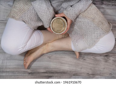 A Comforting Cup Of Coffee In The Hands Of A Woman With A Big, Cosy Jumper
