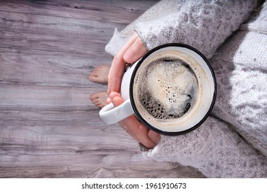 A Comforting Cup Of Coffee In The Hands Of A Woman With A Big, Cosy Jumper
