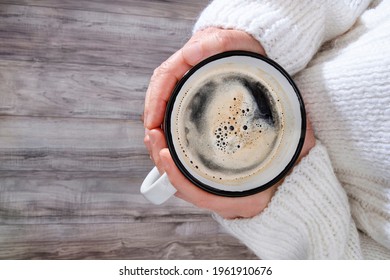 A Comforting Cup Of Coffee In The Hands Of A Woman With A Big, Cosy Jumper
