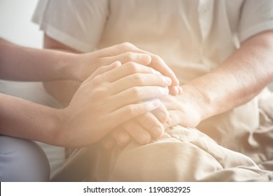 Comforting Hand. Young Nurse Holding Old Man's Hand. Senior Care, Care Taker And Senior Retirement Home Service Concept. Close Up Shot.