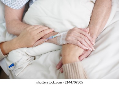 Comforting A Sick Family Member. Cropped Image Of An Affectionate Daughters Hand Being Held By Her Mother In The Hospital.