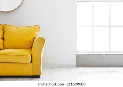 Comfy Yellow Sofa Near Light Wall