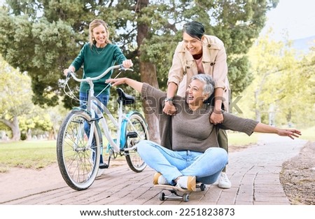 Comic, happy and retirement friends in park for silly outdoor fun with skateboard and bicycle. Funny, goofy and senior women in nature with excited smile for bonding wellness together.