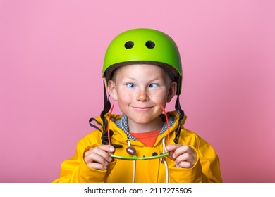 Comic little kid boy make grimace with eyes strabismus. Child with crosses-eyes with glasses in hands. Happy child with squint eyes.