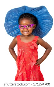 Comical Portrait Of Small African Girl Wearing Big Blue Hat.Isolated On White Background.