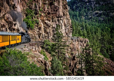 Coming Around the Mountain/The Durango Silverton Narrow Gauge Railroad takes passengers along sheer cliffs and around mountain bends.
