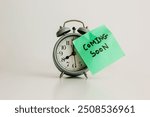 Coming soon. Coming Soon Alarm Clock Reminder. Alarm clock with "coming soon" post-it