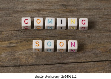 coming soon text on a wooden background