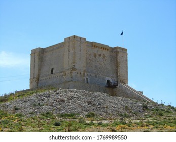 COMINO, MALTA - Apr 27, 2014: Santa Marija Tower, built by Knights Order of St John, over the cliffs and blue sea on the island of Comino, Malta. Prison in Count of Monte Cristo
