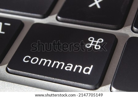 Command button on a laptop. Macro photography of a keyboard button. Symbol of commanding