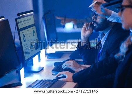 Command center lead focused intense monitoring critical systems late night headset connects team analyzing real time data screen crucial vigilance protects infrastructure operation underway now execut