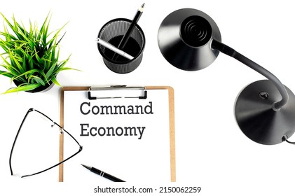 COMMAND ECONOMY Text On Clipboard On The White Background