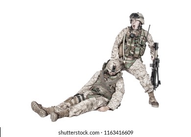 Commando soldier screaming and dragging backwards for plate carrier wounded and unconscious comrade. Tactical combat casualty care, injured combatant evacuating from battlefield, isolated on white - Powered by Shutterstock