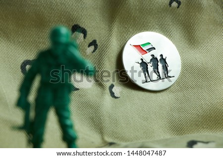 Commemoration Day badge - army toy in front of Commemoration Day badge