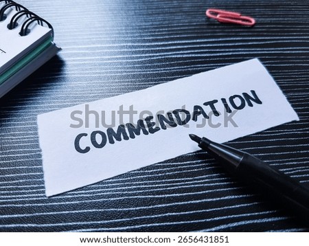 Commendation writting on table background.
