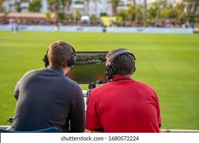 commentators on football game watching match. stream for television and radio