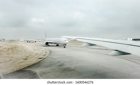 Commercial Aeroplanes, With Logos Removed, Taxiing On A Busy Runway