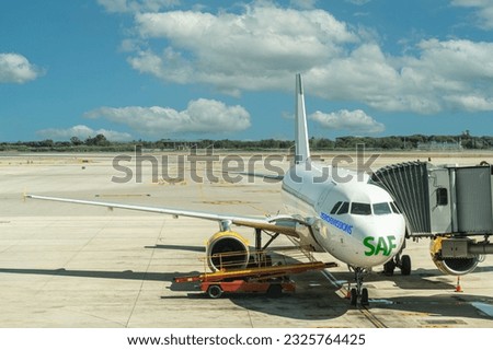 commercial aircraft at airport with SAF text and zero emissions