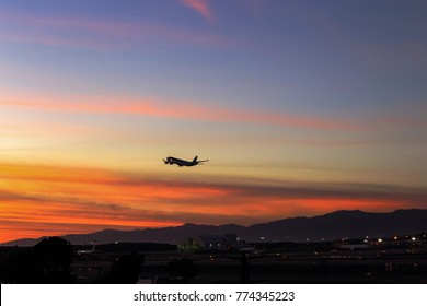 Commercial airliner taking off at LAX flying into twilight sky of southern California 