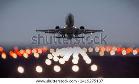 Commercial Airplane Ascending Against A Night Sky Illuminated By Runway Lights