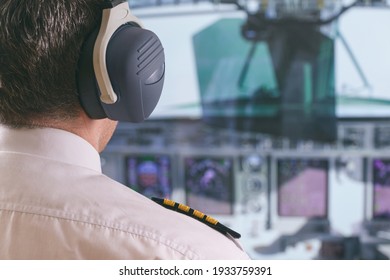 Commercial Airplane Captain In The Cockpit Of A Flying Airplane