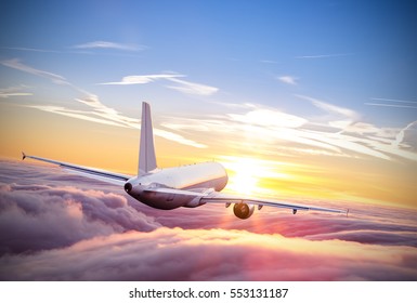 Commercial airplane flying above clouds in dramatic sunset light. Very high resolution of image