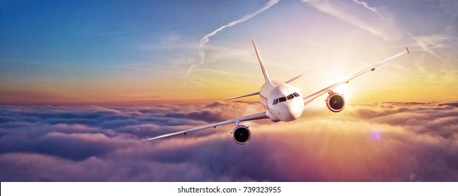 Commercial airplane flying above clouds in dramatic sunset light  High resolution image  Fast Travel   transportation concept