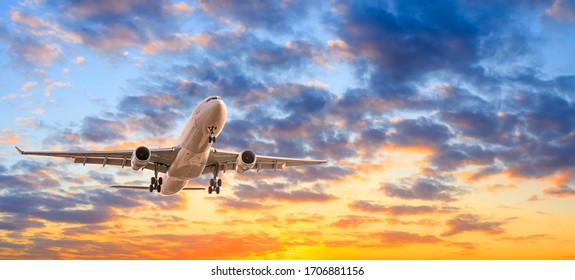 Commercial Airplane Flying In Beautiful Sky At Sunset,travel Concept.