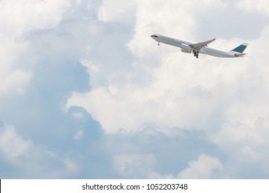 Commercial airplane flying over bright blue sky and white clouds. Elegant Design with copy space for travel concept