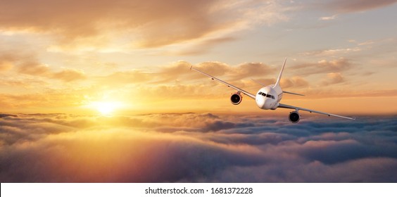 Commercial Airplane Flying Over Dramatic Sunset Sky. Jet Plane Is The Fastest Mode Of Modern Transportation.