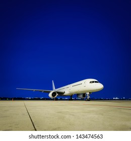 Commercial airplane at night - Shutterstock ID 143474563