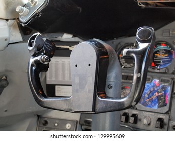 Commercial Airplane Steering Wheel In Cockpit Surrounded By Dials, And Other Instruments.