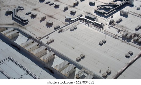 Commercial Building Roof Top In Black And White With Sun Shining And Shadow