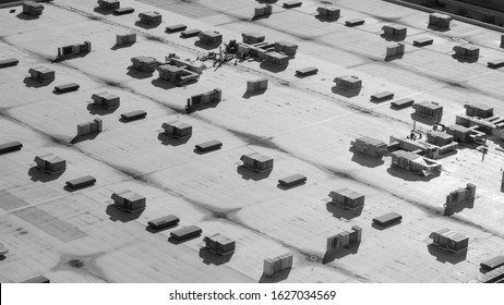 Commercial Building Roof Top In Black And White With Sun Shining And Shadow