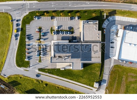 Commercial building (store) with solar panels on the roof. Drone shot